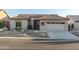 Single story home with a two-car garage and desert landscaping at 7227 E Texas Ebony Dr, Gold Canyon, AZ 85118