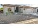 One-story home with gravel landscaping and a two-car garage at 7227 E Texas Ebony Dr, Gold Canyon, AZ 85118