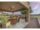 Covered patio with dining and seating areas, offering a tranquil view at 7227 E Texas Ebony Dr, Gold Canyon, AZ 85118