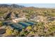 Aerial view of tennis courts and clubhouse near mountains at 7227 E Texas Ebony Dr, Gold Canyon, AZ 85118