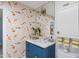 Bathroom with blue vanity, marble countertop, and koi pond wallpaper at 7528 N 10Th St, Phoenix, AZ 85020