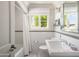 Classic bathroom with white subway tile, a bathtub, and window at 7528 N 10Th St, Phoenix, AZ 85020