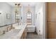 Modern bathroom with marble countertops, double sinks, and a free-standing bathtub at 7528 N 10Th St, Phoenix, AZ 85020