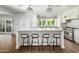 Spacious kitchen with white cabinetry, marble island and breakfast bar at 7528 N 10Th St, Phoenix, AZ 85020