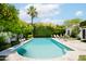 Large kidney-shaped pool surrounded by lush greenery at 7528 N 10Th St, Phoenix, AZ 85020