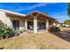 Landscaped backyard with patio and a lemon tree at 7911 E Desert Trl, Mesa, AZ 85208