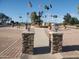 Ornate community fountain with flagpoles at 7911 E Desert Trl, Mesa, AZ 85208