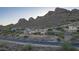 An aerial shot of a house on a hillside with desert landscape and mountain backdrop at 9823 E Dead Sure Pl, Gold Canyon, AZ 85118