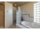 Bathroom with soaking tub, walk-in shower, and glass block wall at 9823 E Dead Sure Pl, Gold Canyon, AZ 85118