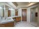 Bathroom with double sinks and wooden cabinets at 9823 E Dead Sure Pl, Gold Canyon, AZ 85118