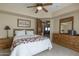 Cozy bedroom with wood furniture and access to a private bathroom at 9823 E Dead Sure Pl, Gold Canyon, AZ 85118