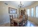 Elegant dining room with large wood table and chandelier at 9823 E Dead Sure Pl, Gold Canyon, AZ 85118