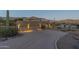 Long private driveway leading to a three-car garage and a desert landscape at 9823 E Dead Sure Pl, Gold Canyon, AZ 85118