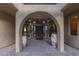 Elegant entryway with arched doorways and large terracotta pots at 9823 E Dead Sure Pl, Gold Canyon, AZ 85118