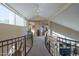 Upper level hallway with curved railing and carpet at 9823 E Dead Sure Pl, Gold Canyon, AZ 85118