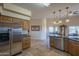 Kitchen features stainless steel appliances and ample wood cabinetry at 9823 E Dead Sure Pl, Gold Canyon, AZ 85118