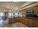 Open kitchen with island, granite countertops and stainless steel appliances at 9823 E Dead Sure Pl, Gold Canyon, AZ 85118