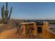 Outdoor kitchen with built-in grill and seating area at 9823 E Dead Sure Pl, Gold Canyon, AZ 85118