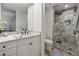 Bathroom with white vanity, tile shower, and toilet at 9909 E Lookout Mountain Dr, Scottsdale, AZ 85262