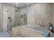 Modern bathroom featuring a glass shower and soaking tub at 9909 E Lookout Mountain Dr, Scottsdale, AZ 85262