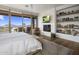 Main bedroom with stunning views, fireplace, and built-in shelves at 9909 E Lookout Mountain Dr, Scottsdale, AZ 85262