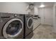 Laundry room with LG washer and dryer and ample storage at 9909 E Lookout Mountain Dr, Scottsdale, AZ 85262