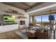 Living room with fireplace, built-in shelving and views at 9909 E Lookout Mountain Dr, Scottsdale, AZ 85262