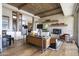 Living room with fireplace, wood beams, and access to patio at 9909 E Lookout Mountain Dr, Scottsdale, AZ 85262