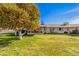 View of home from backyard, showcasing landscaping and trees at 10515 W El Capitan Cir, Sun City, AZ 85351