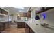 Charming kitchen offering warm-toned wood cabinets, a skylight, and a view into the dining room at 10515 W El Capitan Cir, Sun City, AZ 85351