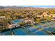 Aerial view of community with pool, tennis courts, and mountain views at 11691 E Turquoise Ave, Scottsdale, AZ 85259