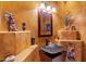 Stylish bathroom with a modern vessel sink and decorative elements at 11691 E Turquoise Ave, Scottsdale, AZ 85259