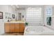 Relaxing bathroom with a soaking tub and a large window at 11691 E Turquoise Ave, Scottsdale, AZ 85259