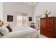 Cozy guest bedroom with a queen-size bed and wood armoire at 11691 E Turquoise Ave, Scottsdale, AZ 85259