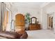 Elegant bedroom with wood furniture and access to a balcony at 11691 E Turquoise Ave, Scottsdale, AZ 85259