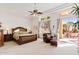 Spacious primary bedroom with king-size bed and access to a patio at 11691 E Turquoise Ave, Scottsdale, AZ 85259