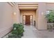 Elegant entryway with double wood doors and decorative glass at 11691 E Turquoise Ave, Scottsdale, AZ 85259