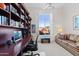 Home office with built-in bookshelves and large window at 11691 E Turquoise Ave, Scottsdale, AZ 85259