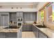 Kitchen with granite countertops, island, and stainless steel appliances at 11691 E Turquoise Ave, Scottsdale, AZ 85259