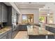 Open concept kitchen with island, granite countertops, and breakfast bar at 11691 E Turquoise Ave, Scottsdale, AZ 85259