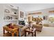 Spacious living room with fireplace, built-in shelving, and large windows at 11691 E Turquoise Ave, Scottsdale, AZ 85259