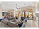 Open floor plan living room with fireplace and access to patio at 11691 E Turquoise Ave, Scottsdale, AZ 85259