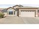 One-story house with a two-car garage and neutral-colored exterior at 11702 W Madison St, Avondale, AZ 85323