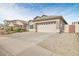 Tan two-story house with a two car garage at 11702 W Madison St, Avondale, AZ 85323