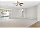 Living room with carpet flooring and sliding glass door to backyard at 11702 W Madison St, Avondale, AZ 85323