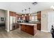 Kitchen with island, stainless steel appliances, and wood cabinets at 12358 W Glenrosa Ave, Avondale, AZ 85392