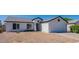 Front view of a charming house with a two-car garage at 1335 E Silver Brush Trl, Casa Grande, AZ 85122