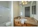 Clean bathroom with tiled countertop, wooden vanity, and a shower/tub combo at 14065 N 111Th Pl, Scottsdale, AZ 85255