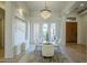 Sunlit dining room with a glass table and chandelier, views to backyard at 14065 N 111Th Pl, Scottsdale, AZ 85255