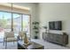 Living room with sliding glass doors, pool view, and modern decor at 14065 N 111Th Pl, Scottsdale, AZ 85255